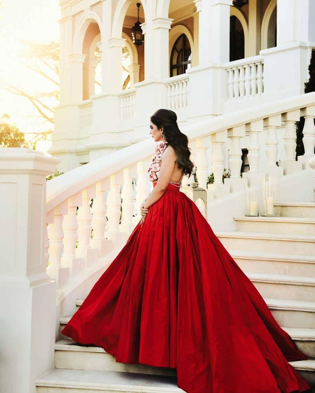 Isha looked resplendent in a voluminous vibrant red silk taffeta gown, accompanied by a rose gold crystal roses halter top by Tamara Ralph. 