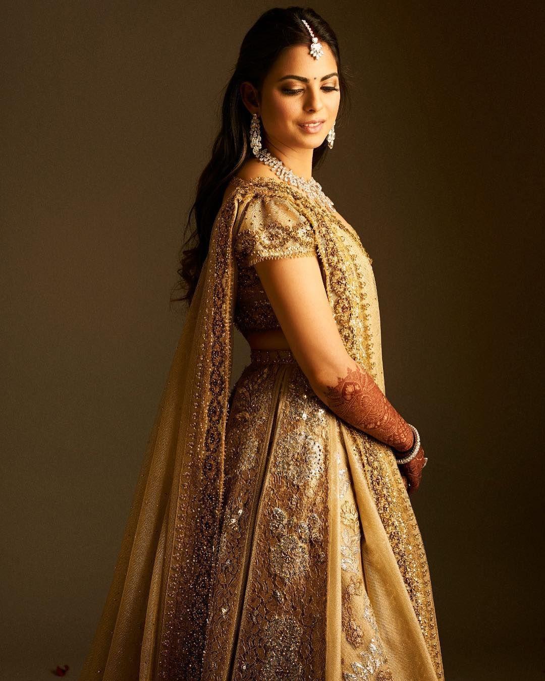  If you want to stand out with a bridal lehenga that isn't red or pink, consider a bold statement in gold, following Ambani's lead. Pair it with diamond jewelry to complement the gold hue. 