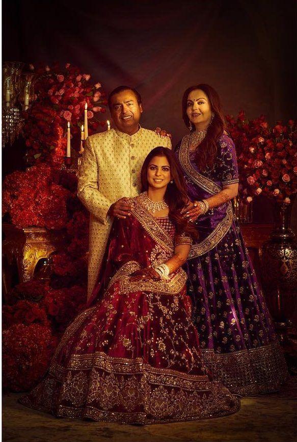 The entire family donned custom-made outfits by the popular designer Sabyasachi. Nita Ambani opted for a purple velvet lehenga. Mukesh Ambani complemented them in a peach Sabyasachi sherwani. 