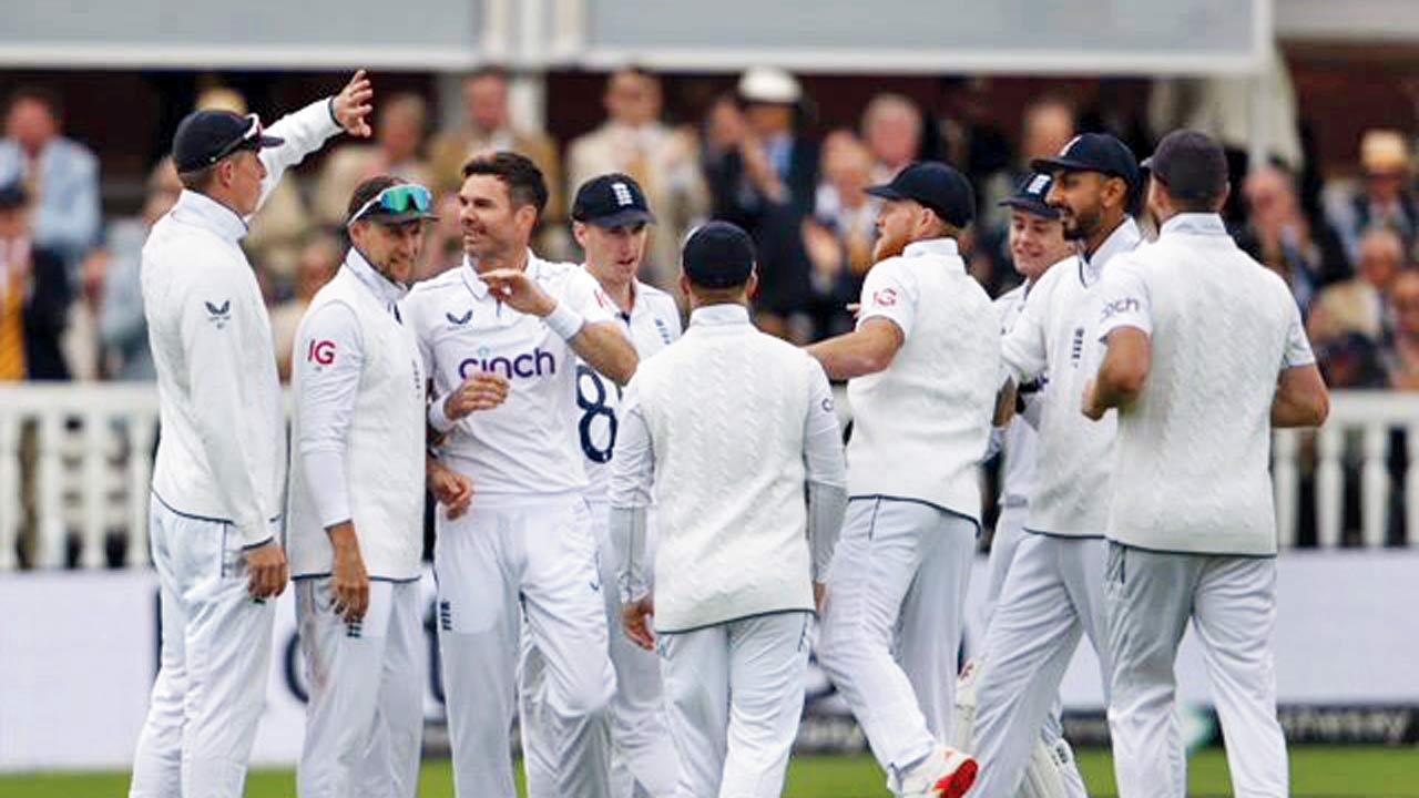 England’s James Anderson (third from left) celebrates a WI wicket with his teammates yesterday. Pics/Bipin Patel  