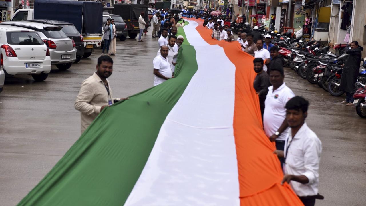 People were seen holding the Indian tricolour during a tribute parade on Friday on the streets of Chikkamagaluru