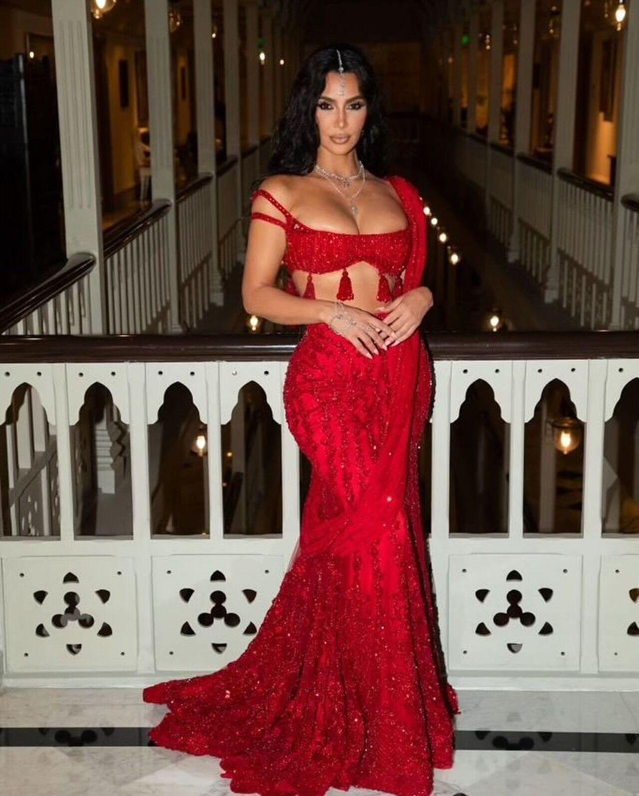 Kim chose a shimmery red saree by Manish Malhotra and teamed it with a matching bralette blouse. Tassel detailing at the hemline of the midriff-baring blouse amped up her outfit.