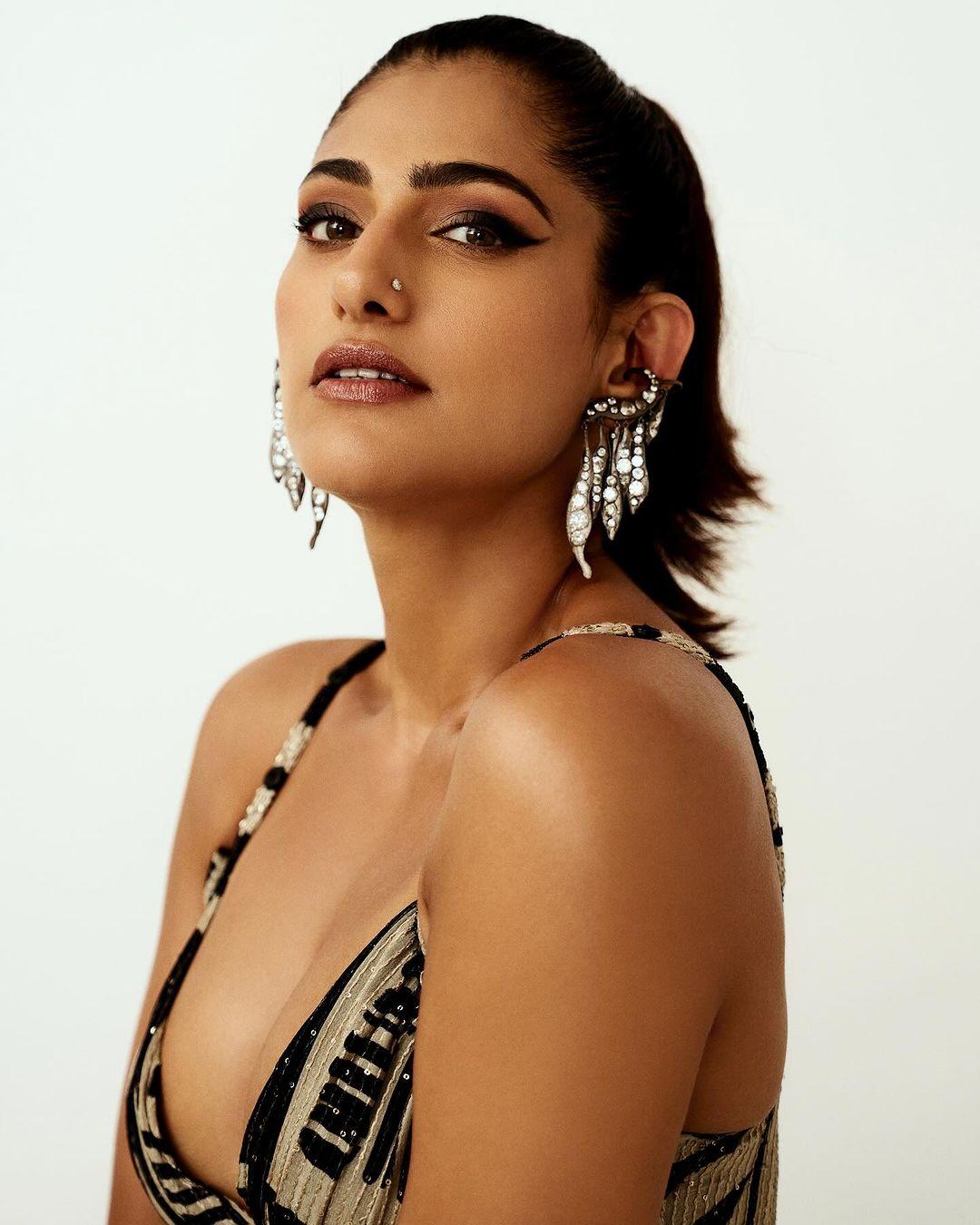The dress features a unique and trendy design, making her stand out as a fashion trendsetter. 