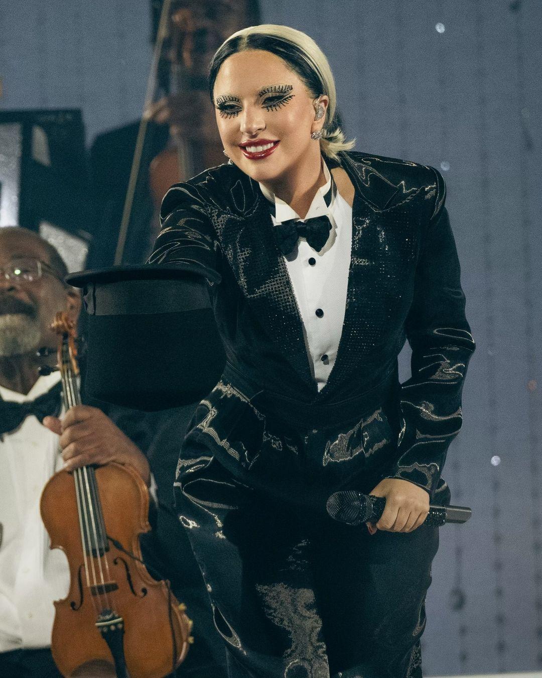 Lady Gaga brought her signature flair to her Vegas shows. In one outfit, she wore a black tuxedo with a shimmering jacket. Her eye makeup was extravagant and impossible to miss.