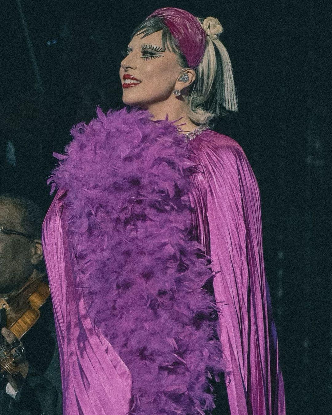 In another jaw-dropping picture, Lady Gaga sported a stunning pink/purple gown adorned with numerous feathers.