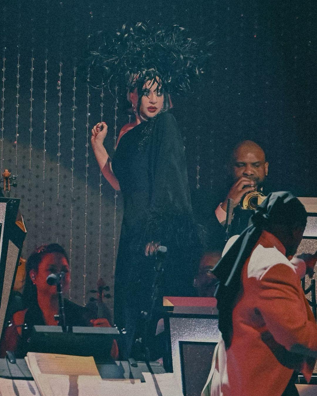 In another picture, Lady Gaga was seen wearing a black satin gown that was asymmetrical.