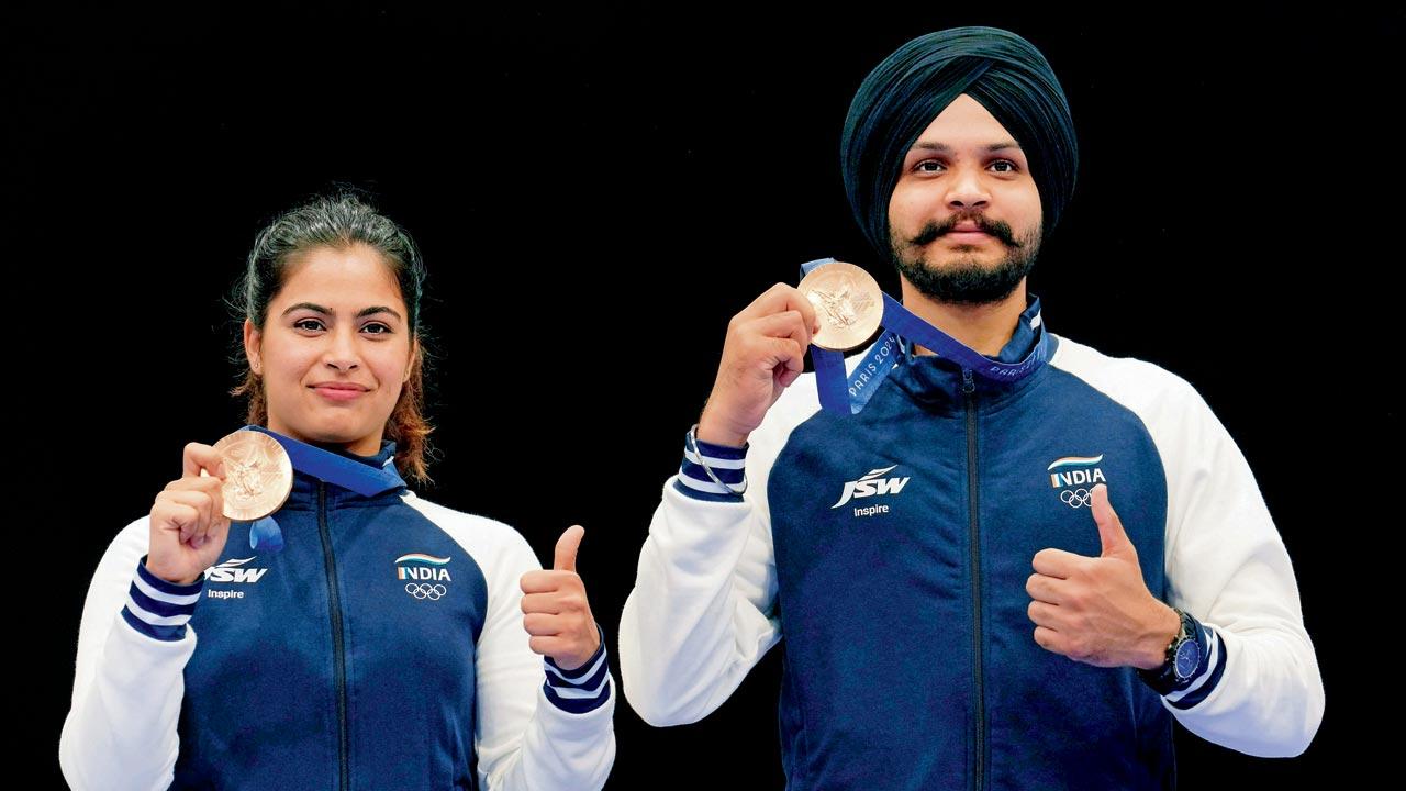 Manu Bhaker and Sarabjot Singh with their 10m air pistol mixed team bronze medals in Paris. Pic/AP, PTI