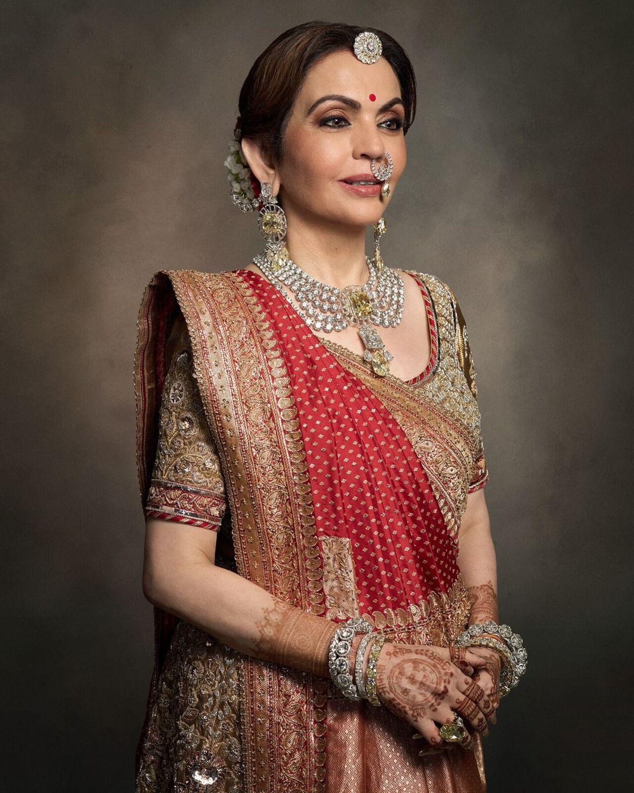 For the wedding, Nita wore a handwoven wonder by the talented craftsmen of ‘Swadesh’. Clad in a real tissue gold ghagra paired with a real gold tissue blouse hand-embroidered in zardozi, she looked elegant with a red tissue dupatta adorned with naqshi and zardozi work decorated with Swarovski crystals and a classic Banarasi zari saree. 