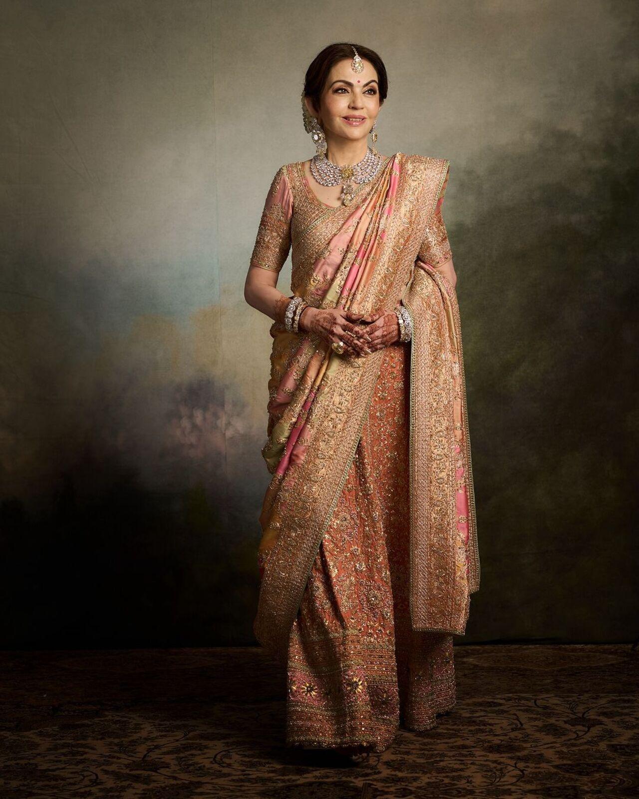 For the baraat, Nita wore a custom Abu Jani Sandeep Khosla ‘Rangkat’ ghagra. The peach silk ghagra combined hues of vintage bronze, blushing pink, and pistachio green. 