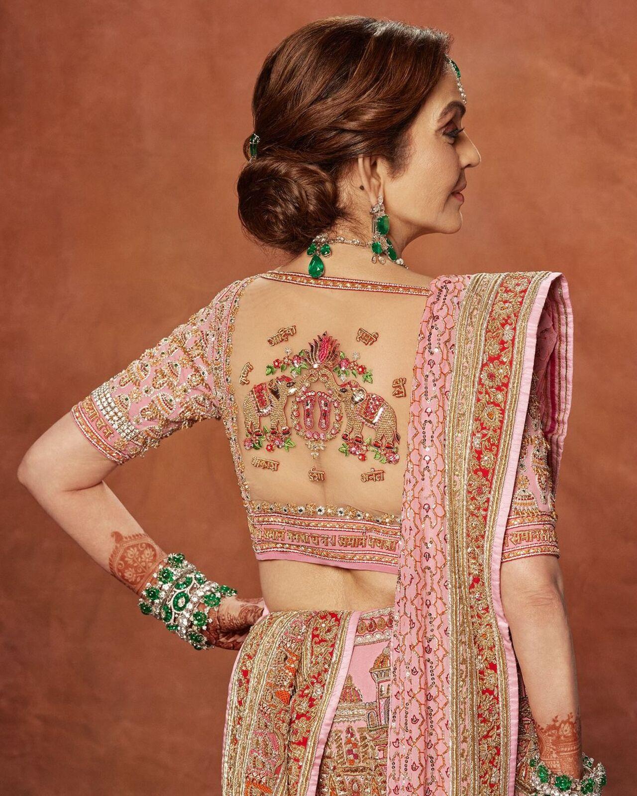 Nita Ambani wore a custom Abu Jani Sandeep Khosla couture that honored family, love, and the finest craftsmanship. Her bespoke lehenga featured Hindi text on its borders, and names of her grandchildren. 