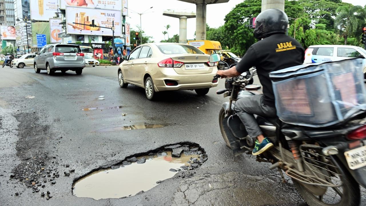 Vehicles were seen navigating around the potholes which were filled with water 