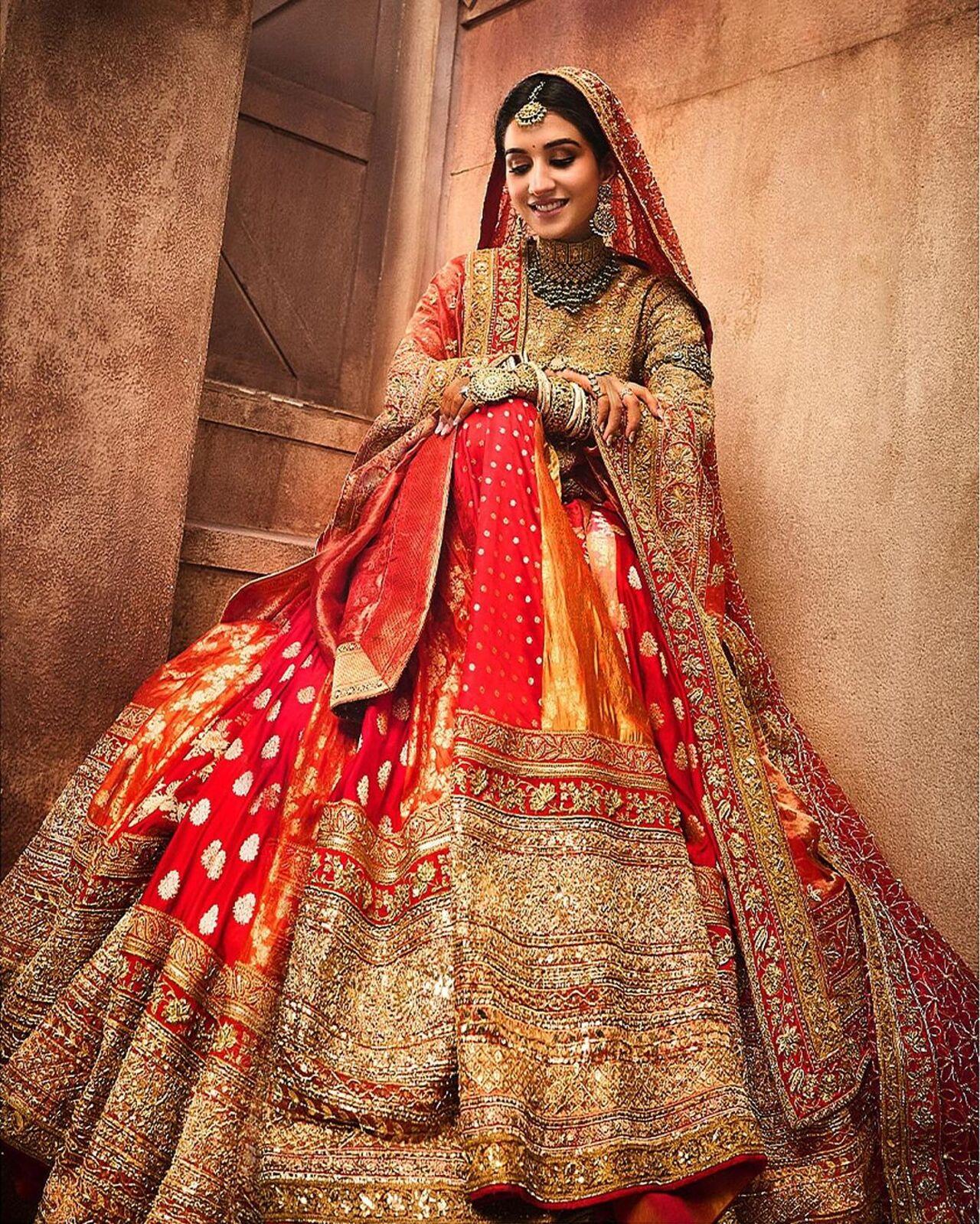 Completing her ensemble, Radhika draped a Banarasi silk dupatta with real gold embroidery and Resham work over her shoulder, paired with a veil cascading into a dramatic train