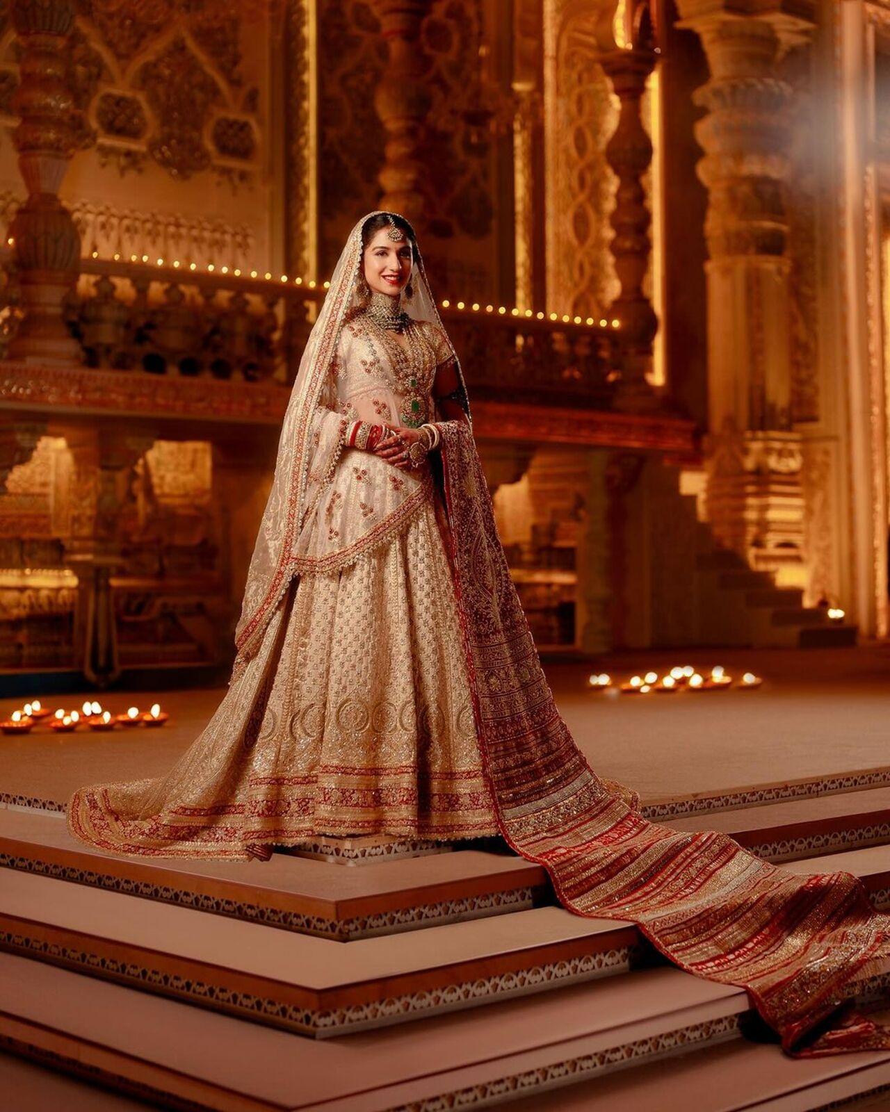 Her bridal ensemble is Abu Sandeep's exquisite interpretation of 'Panetar' - The Gujarati tradition of brides wearing red and white on their big day, styled most thoughtfully by Rhea Kapoor.