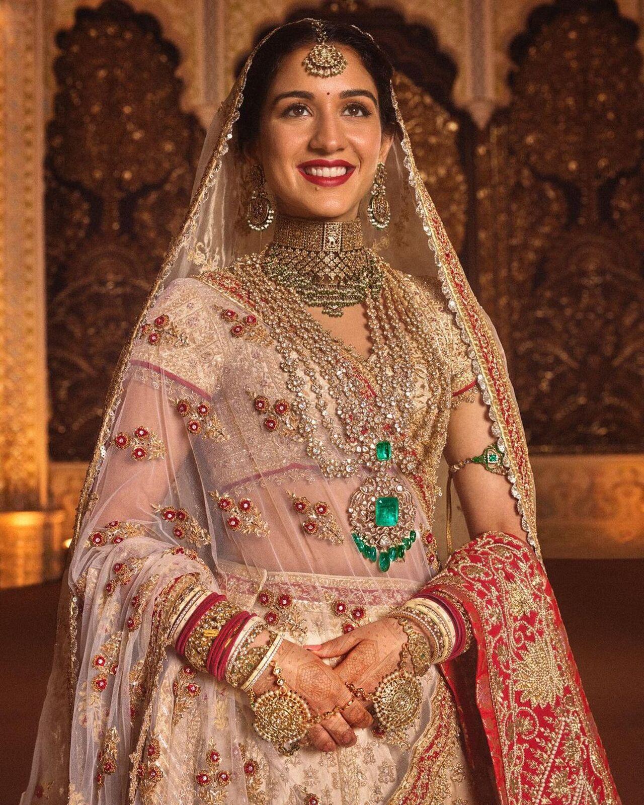 The newlywed donned a traditional ivory and red lehenga by Abu Jani Sandeep Khosla for her wedding
