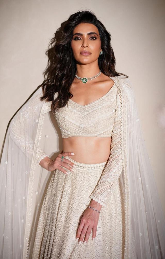 Karishma Tanna was a vision in white as she dons a caped lehenga by Ritika Mirchandani. 