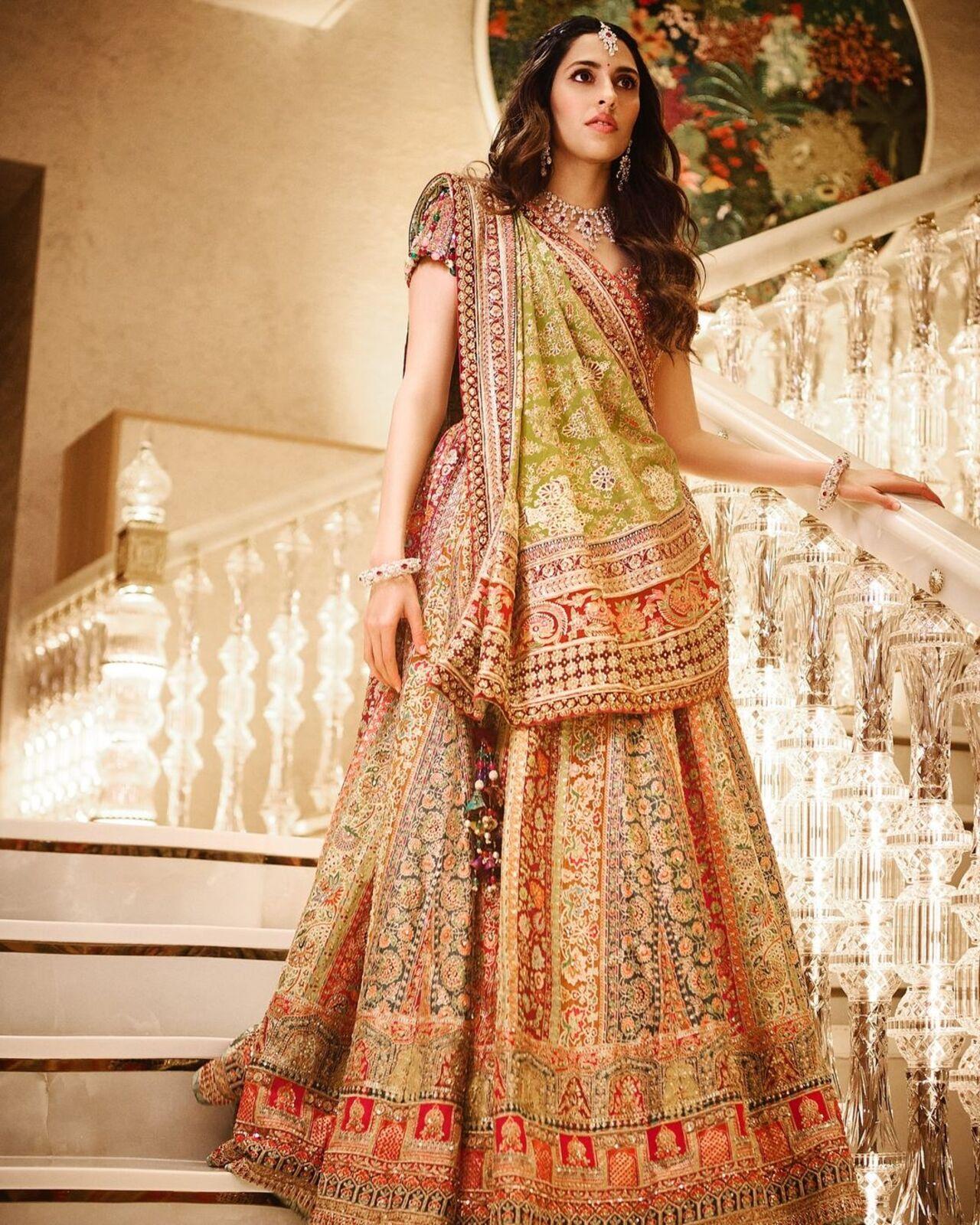 For the traditional garba night, Shloka wore a traditional Jamawar shawl-inspired multi-colored lehenga by Tarun Tahiliani. 