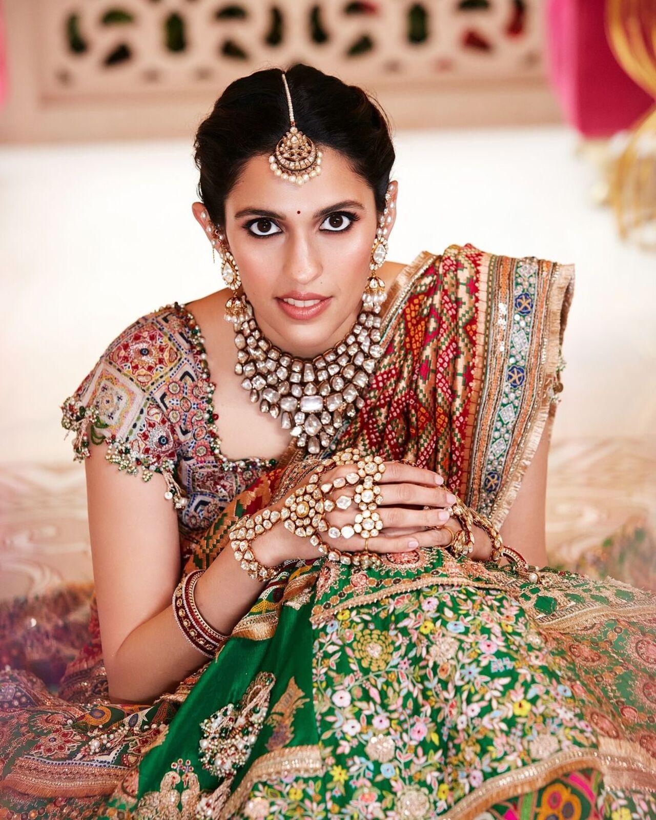 For the Haldi ceremony, Shloka Ambani wore a printed red and green lehenga designed by Anamika Khanna. 
