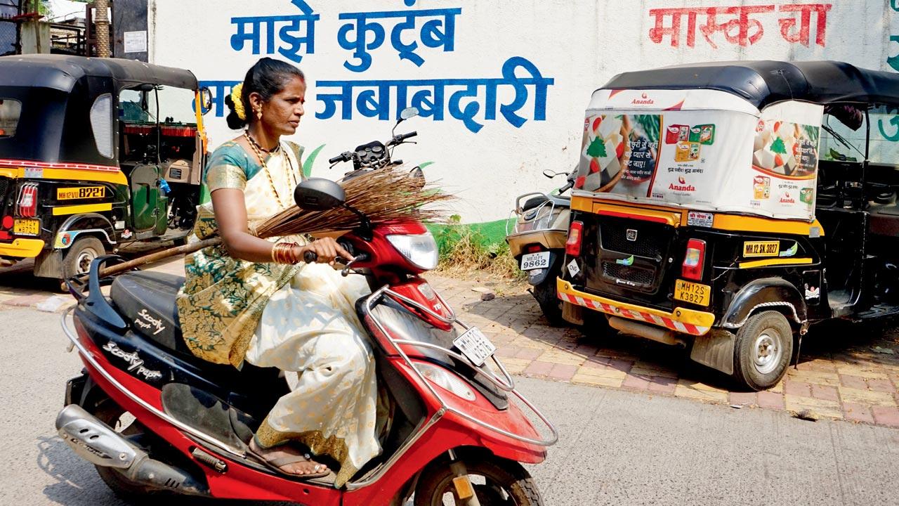 Armed with brooms, waste picker Vaishali Kasbe rides ahead. Pics Courtesy/Vidyasagar Sonawane for Swach Cooperative, Pune