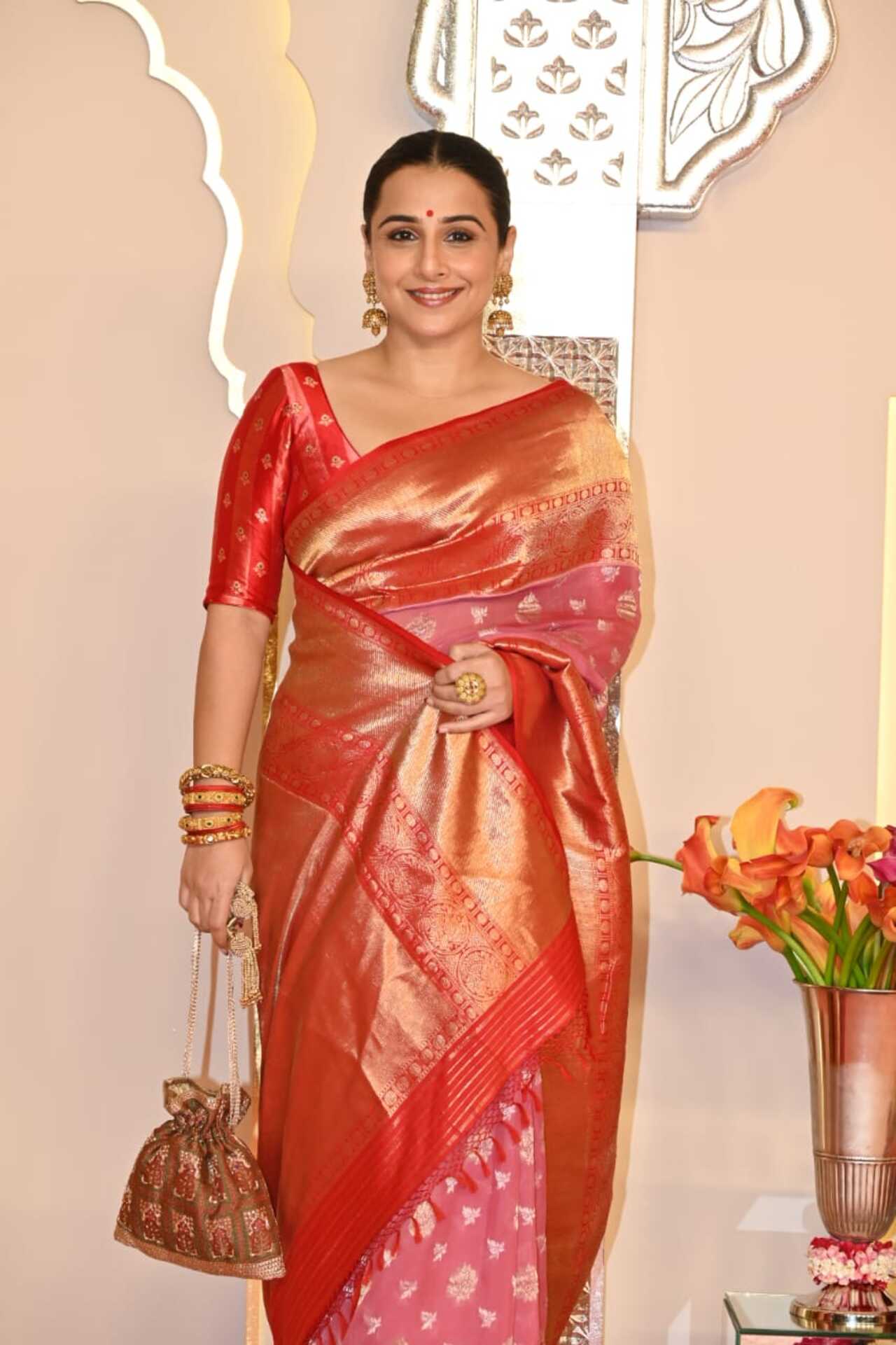 Vidya Balan opted for stunning red saree and paired it with a chic bun hairstyle