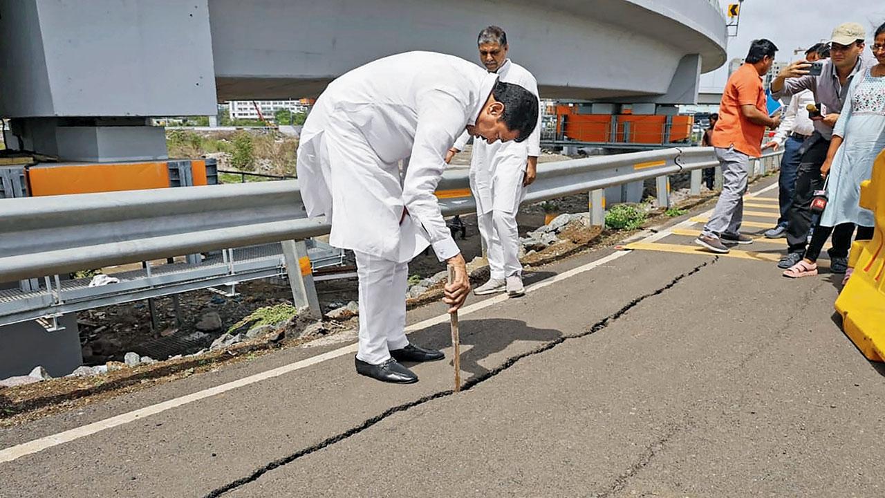 Congress leader Nana Patole inspects the crack that appeared on the approach road. Pic/PTI