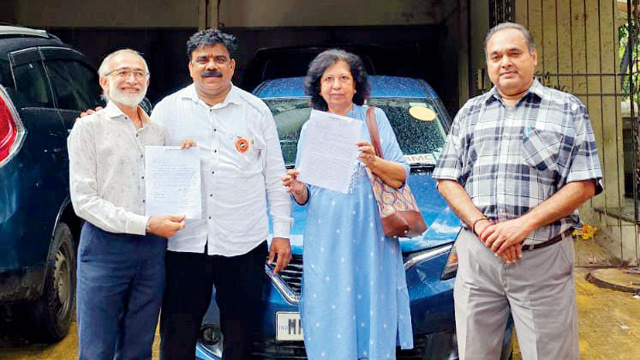 MNS leader Dinesh Salvi (second from left) and society members with the letter from the BMC