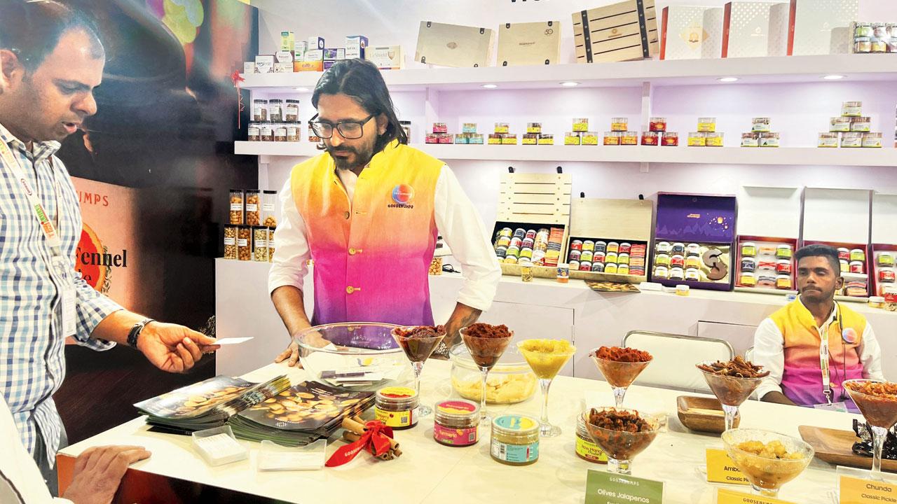 Pinank Shah (right) serves pickled treats to visitors at a previous pop up in the city
