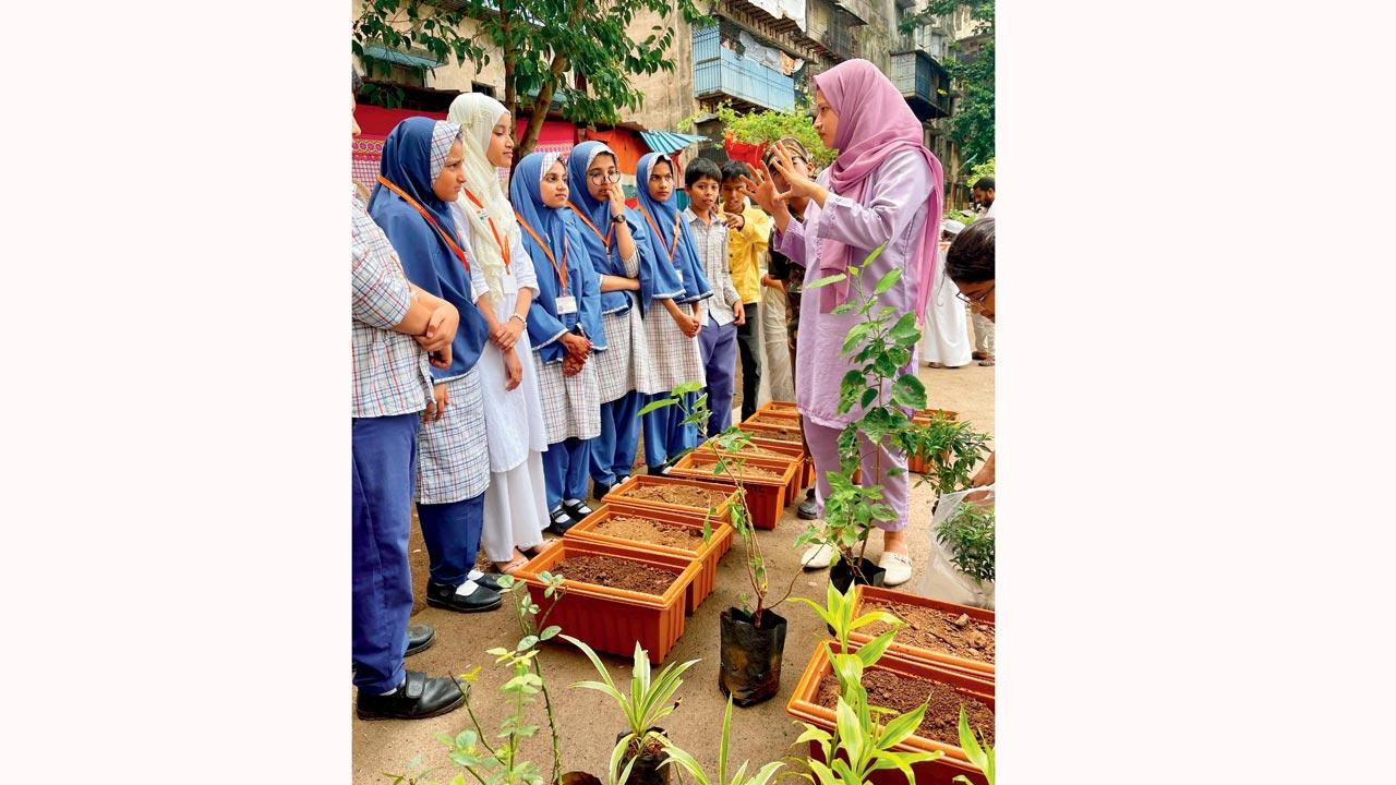 Zia Fatima interacts with children during a plantation drive