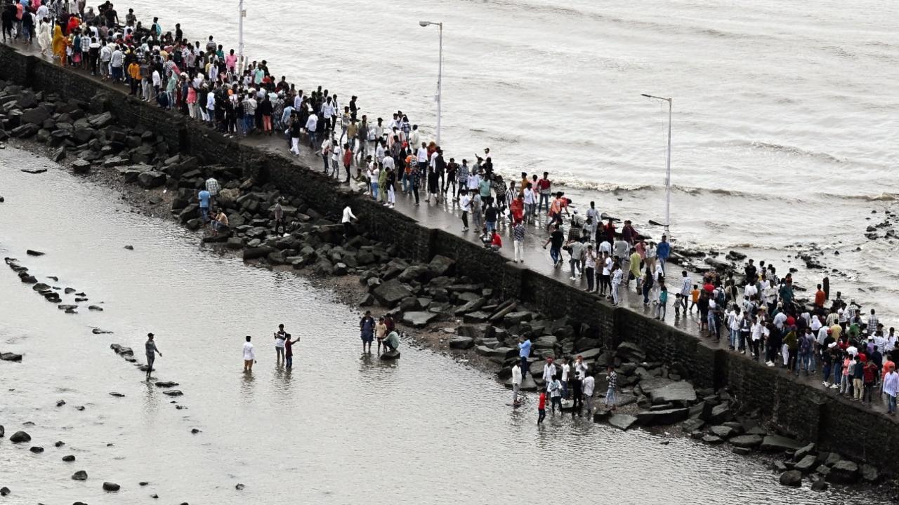 Many people, after offering their prayers, were spotted standing alongside the coast and revelling with their near and dear ones.