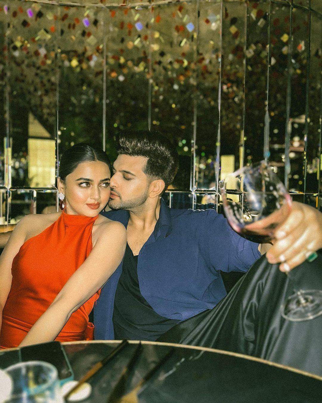 In this picture, the actress is seen in a stylish red-hot dress while Karan complements her with a stylish look
