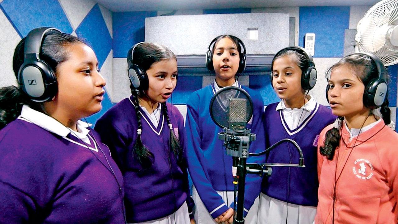 Young female artistes record inside the studio space housed by the bus