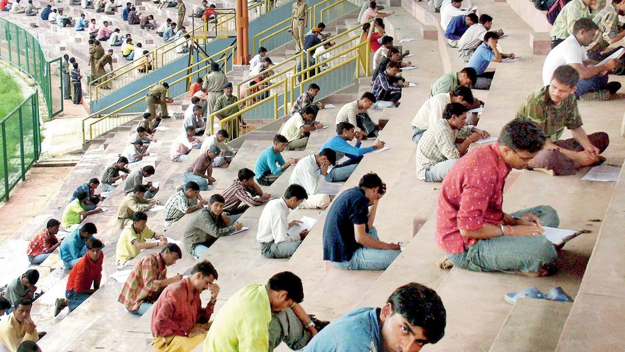 A file pic of young Indian men taking an entrance exam, hoping to secure for one of 1,500 vacant posts in the Madhya Pradesh State Police Department in Bhopal amid rising unemployment in the state. Pic/Getty Images