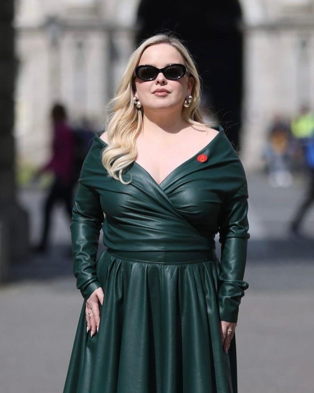 In another picture, Nicola looked stunning in an off-shoulder green button-up shirt dress. The form-fitting dress accentuated her curvaceous figure.