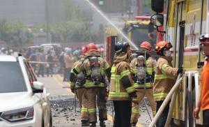 In Photos: South Korean rescuers search burned factory after blaze killed 22