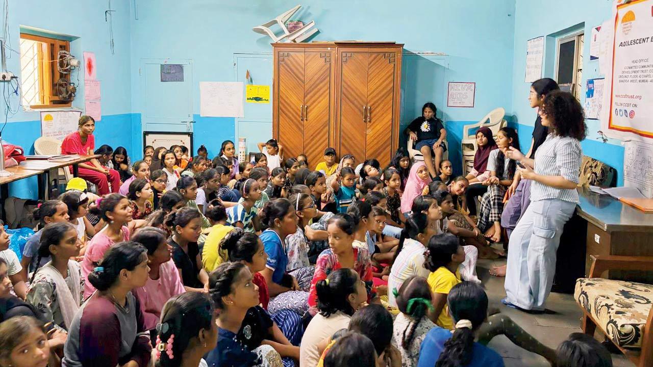 The students listen as the educators explain at the session in Dharavi