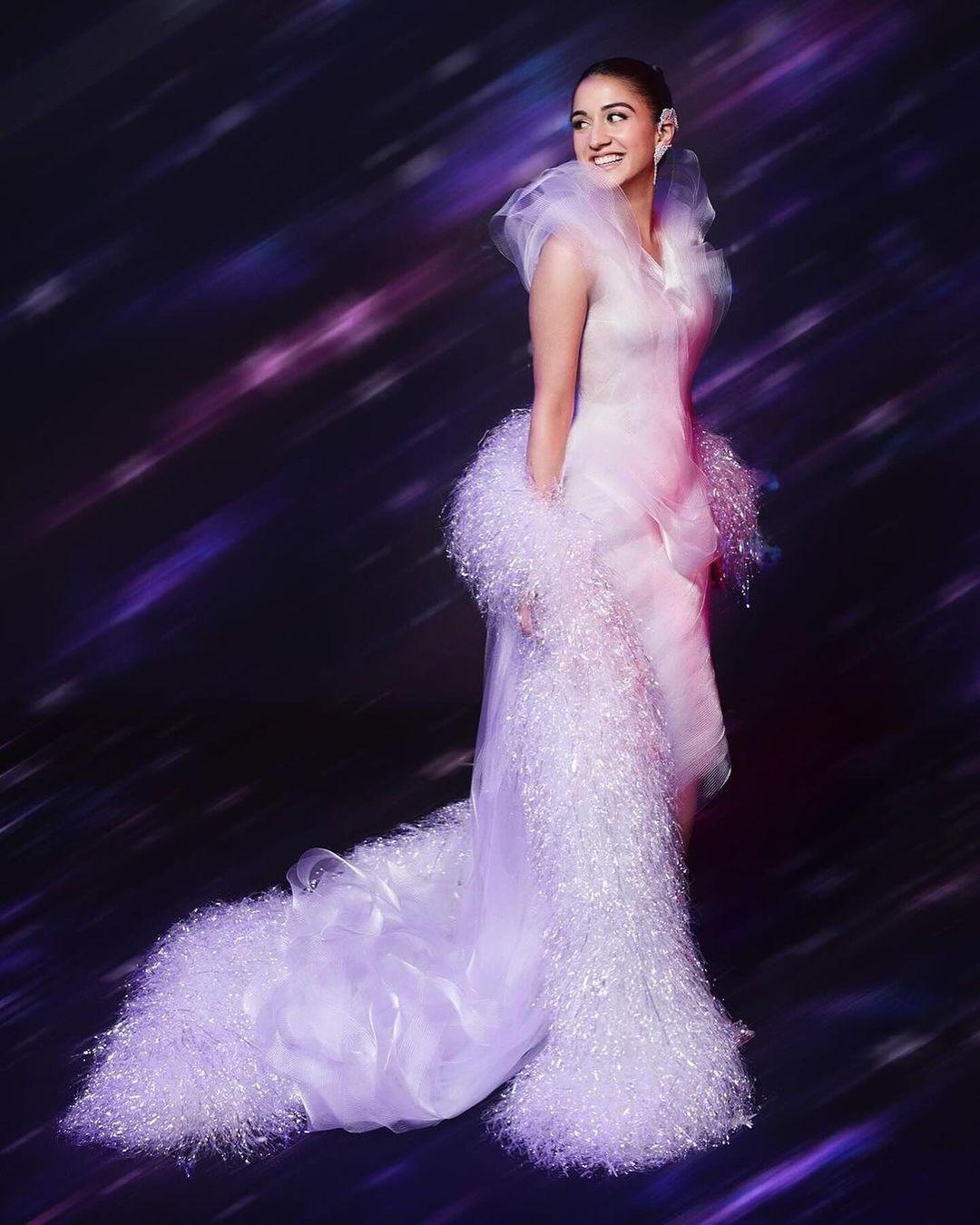 Radhika Merchant has also been serving many looks. This outfit is from the high-end fashion brand Lever Couture. The photos show Radhika looking stunning in the tulle dress, which is styled with a dramatic feather cape.
