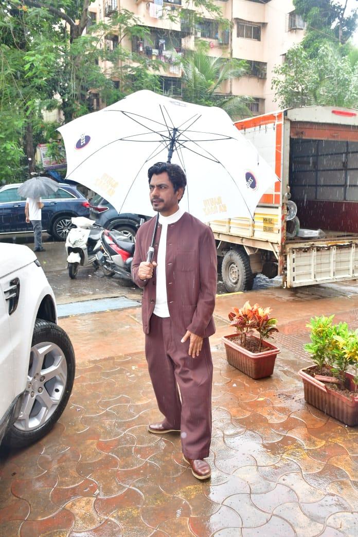 Nawazuddin Siddique looked cute as holds an umbrella in his hand
