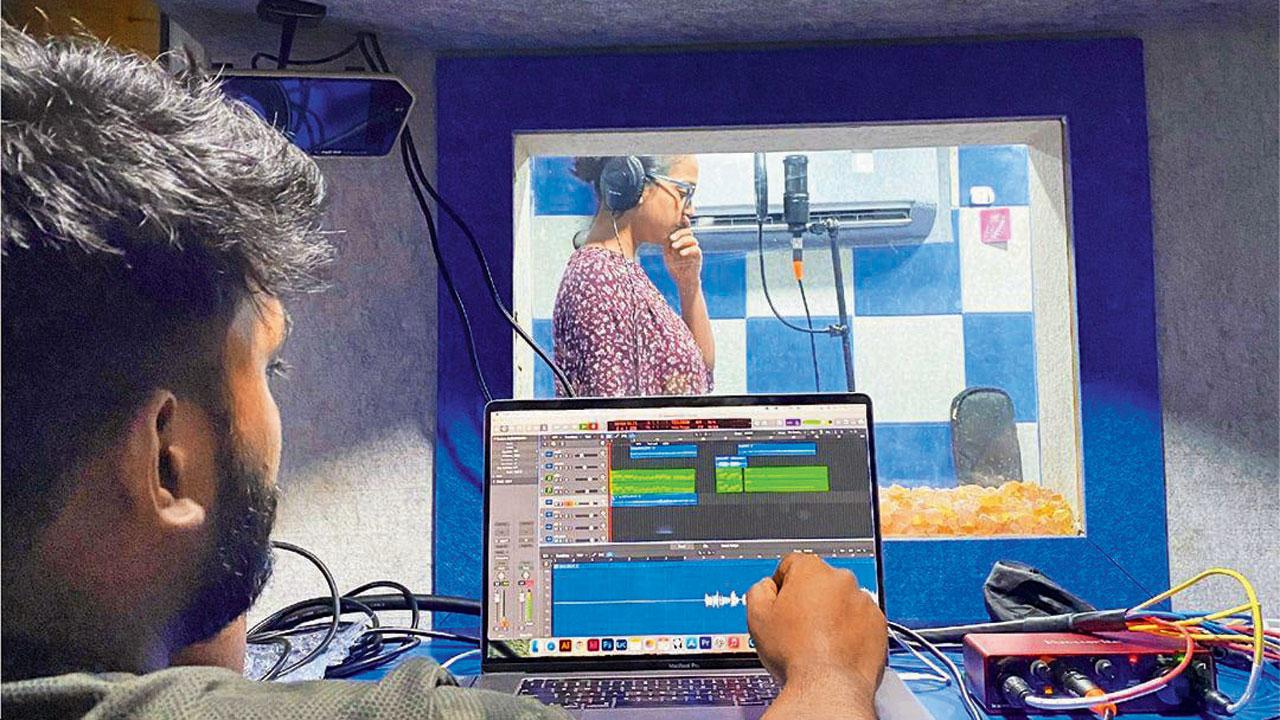 A technician operates the audio console inside the bus