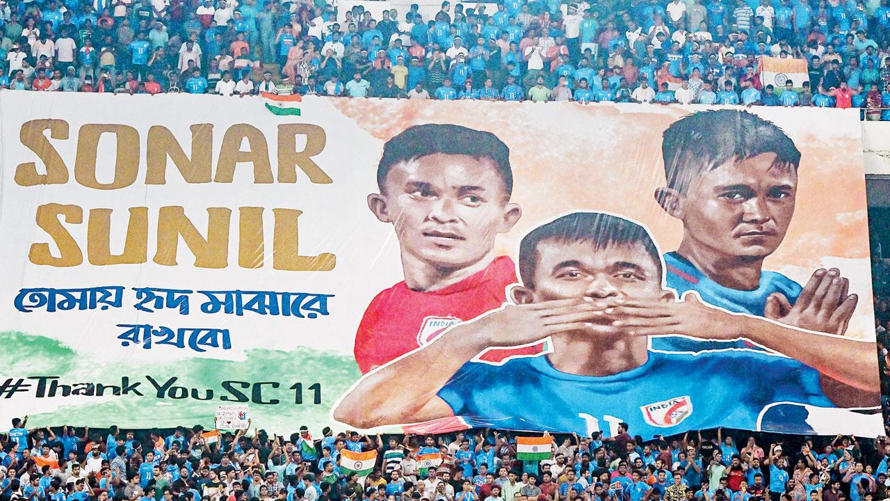 Fans with a Sunil Chhetri banner in Kolkata yesterday. PIC/AFP