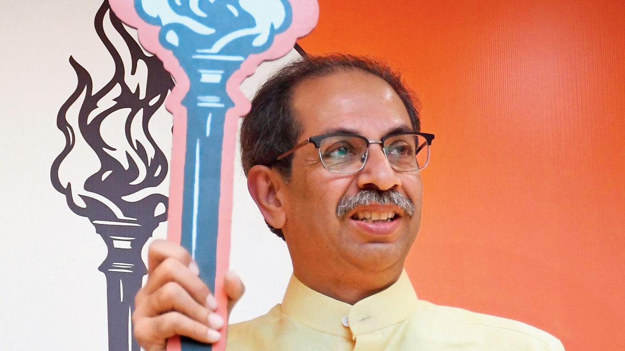 Uddhav Thackeray showing the Shiv Sena (UBT) symbol—the mashal—to the press. File pic/Ashish Raje