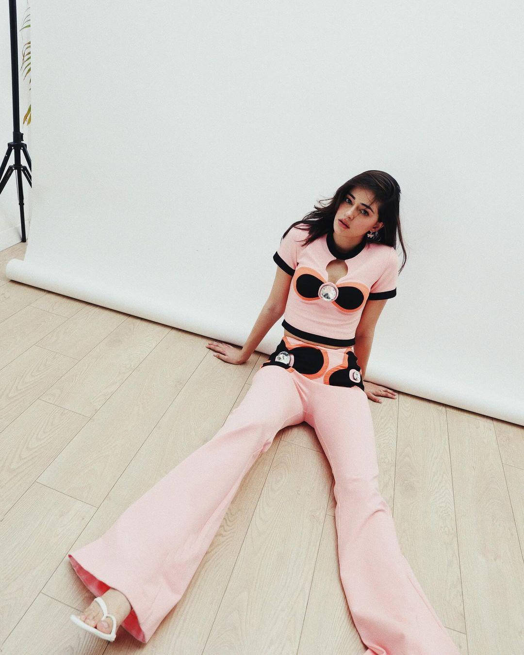 She matched it perfectly with compact jersey flare pants featuring color block flower intarsia and crystal details.