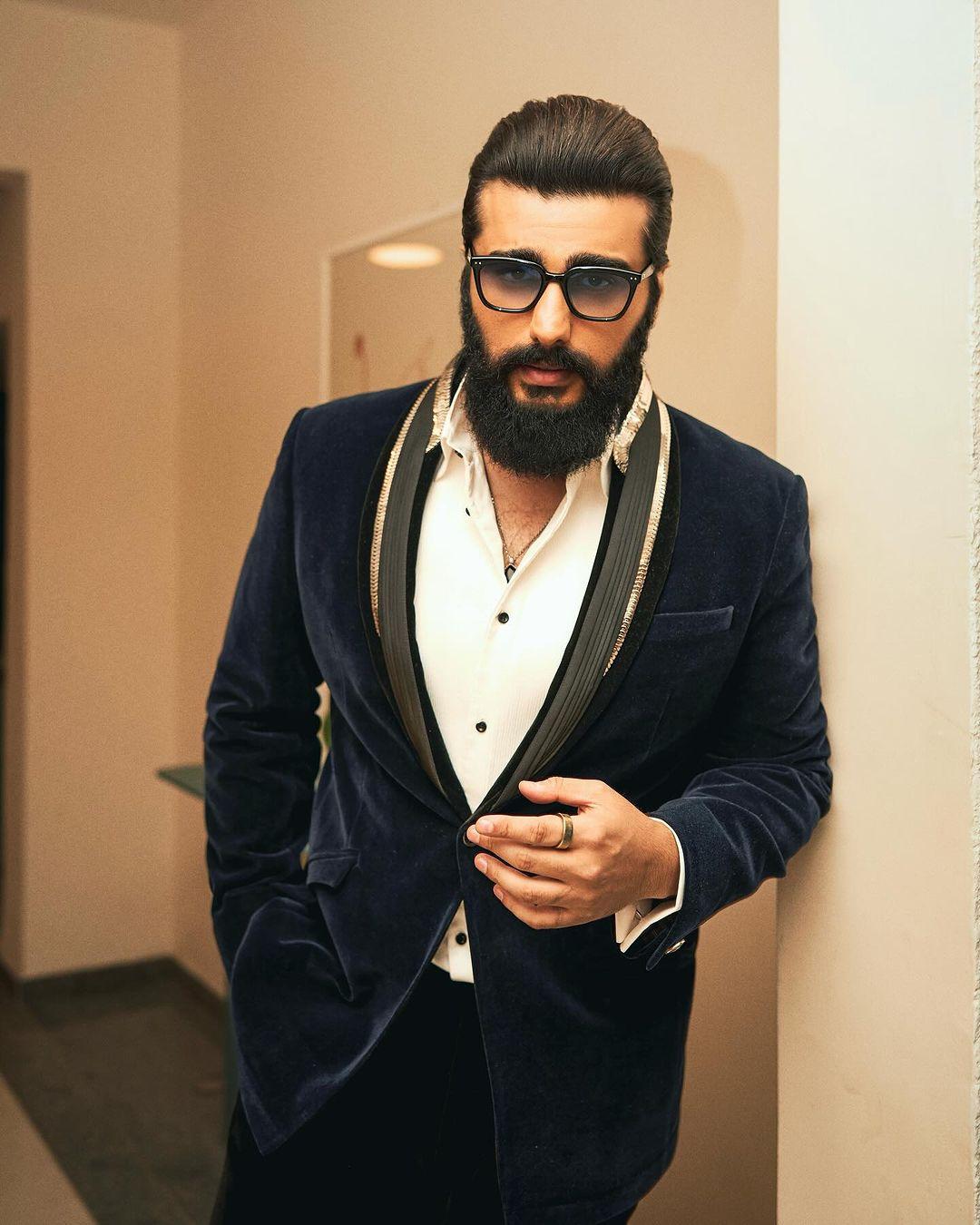 Arjun Kapoor is sporting a classic black and white suit, looking dapper as ever.