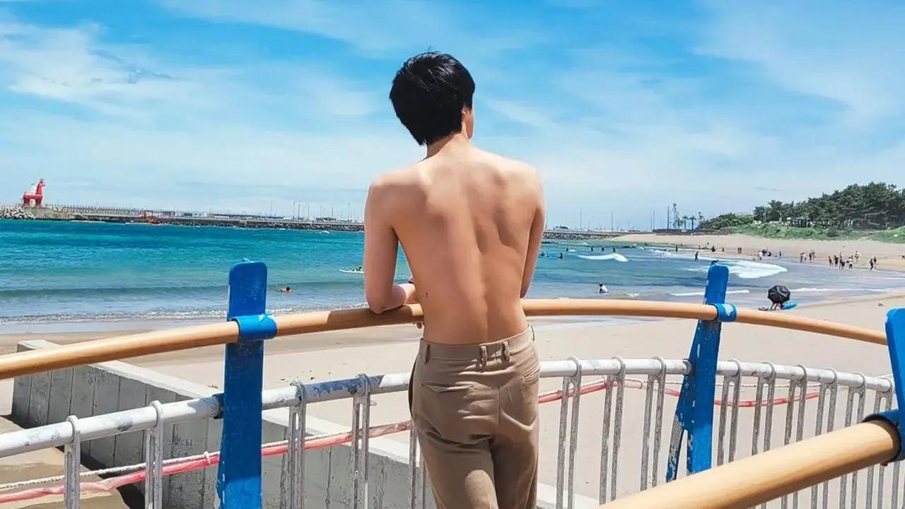 BTS star Jin posted shirtless pictures on Instagram, showing off his friendship tattoo. As part of the group's pact, he got the number 7 inked on his waist. Jin shared the photos, posing at the beach.
