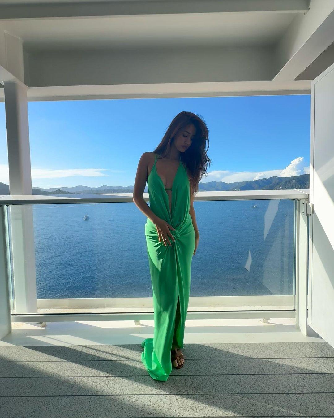 In the pictures, she's enjoying the summer in a green maxi dress while posing on a cruise in Italy.