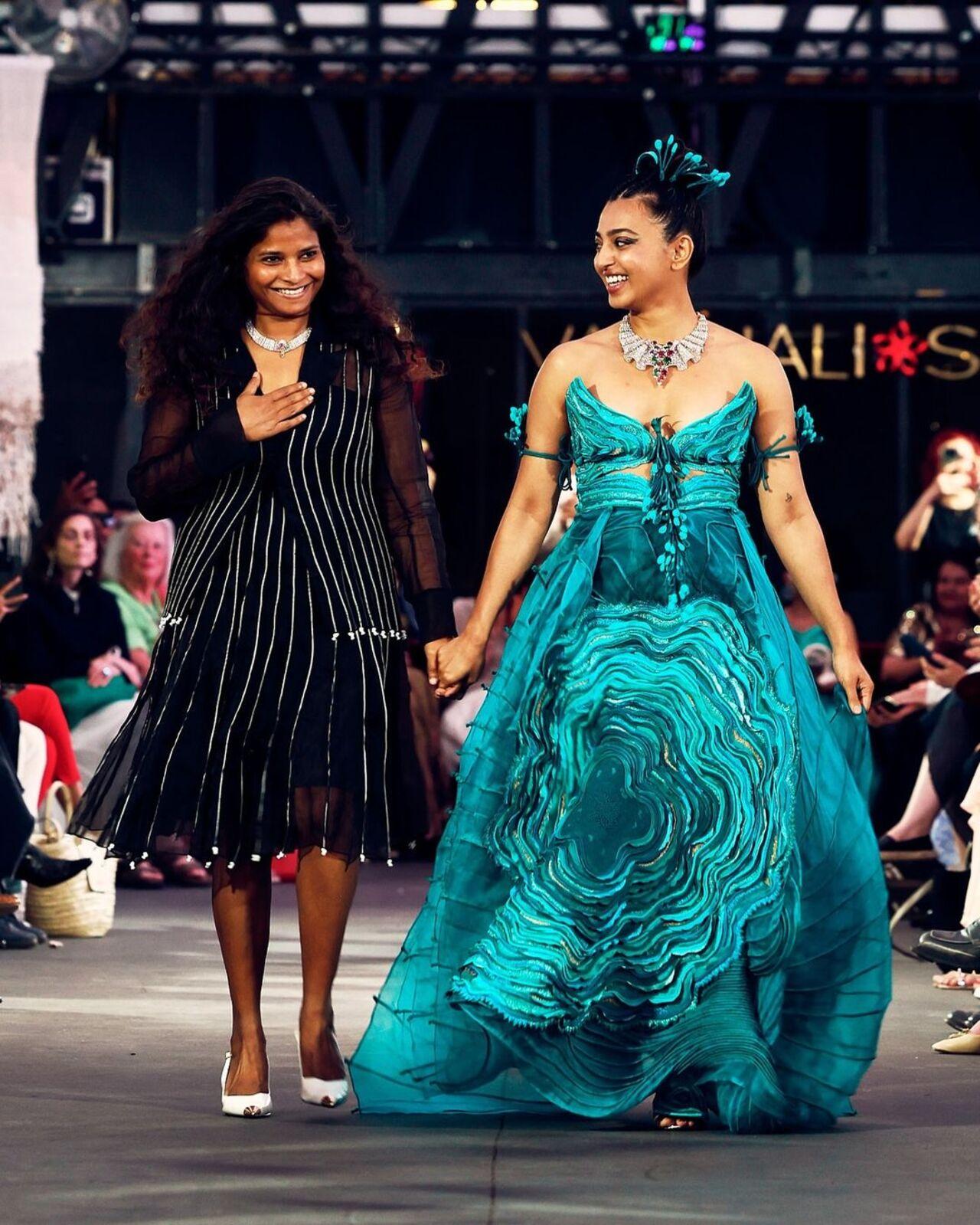 The showcase was in partnership with the jewellery brand Tanishq. Radhika mesmerised in a strapless blue outfit exuding mermaid vibes. The design symbolises the sunrise, sunshine, and ripples of water, capturing nature’s ever-changing landscape
