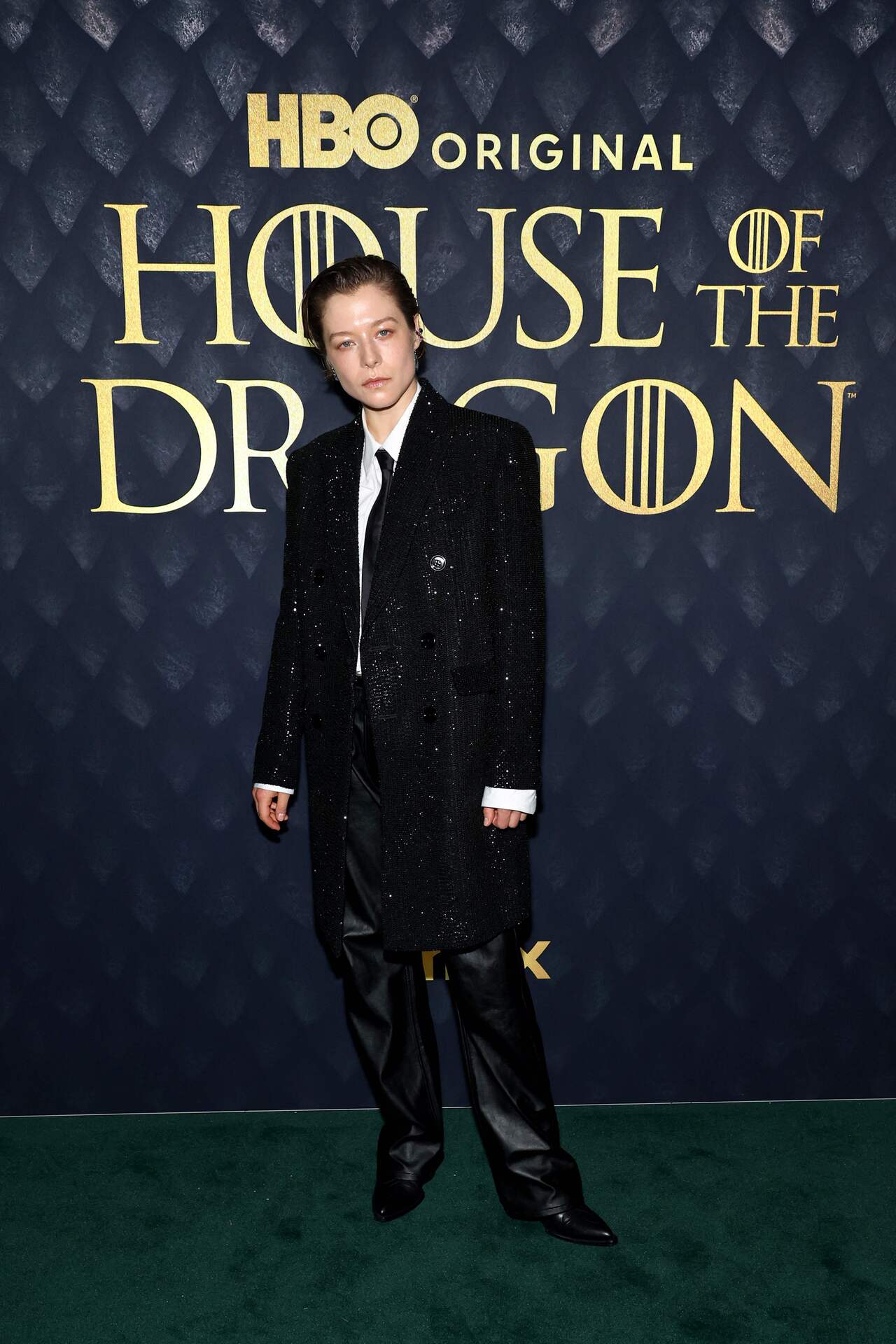 Emma D’Arcy opted for an androgynous look with her shimmery black suit, leather trousers, a white shirt, and a black tie. 
