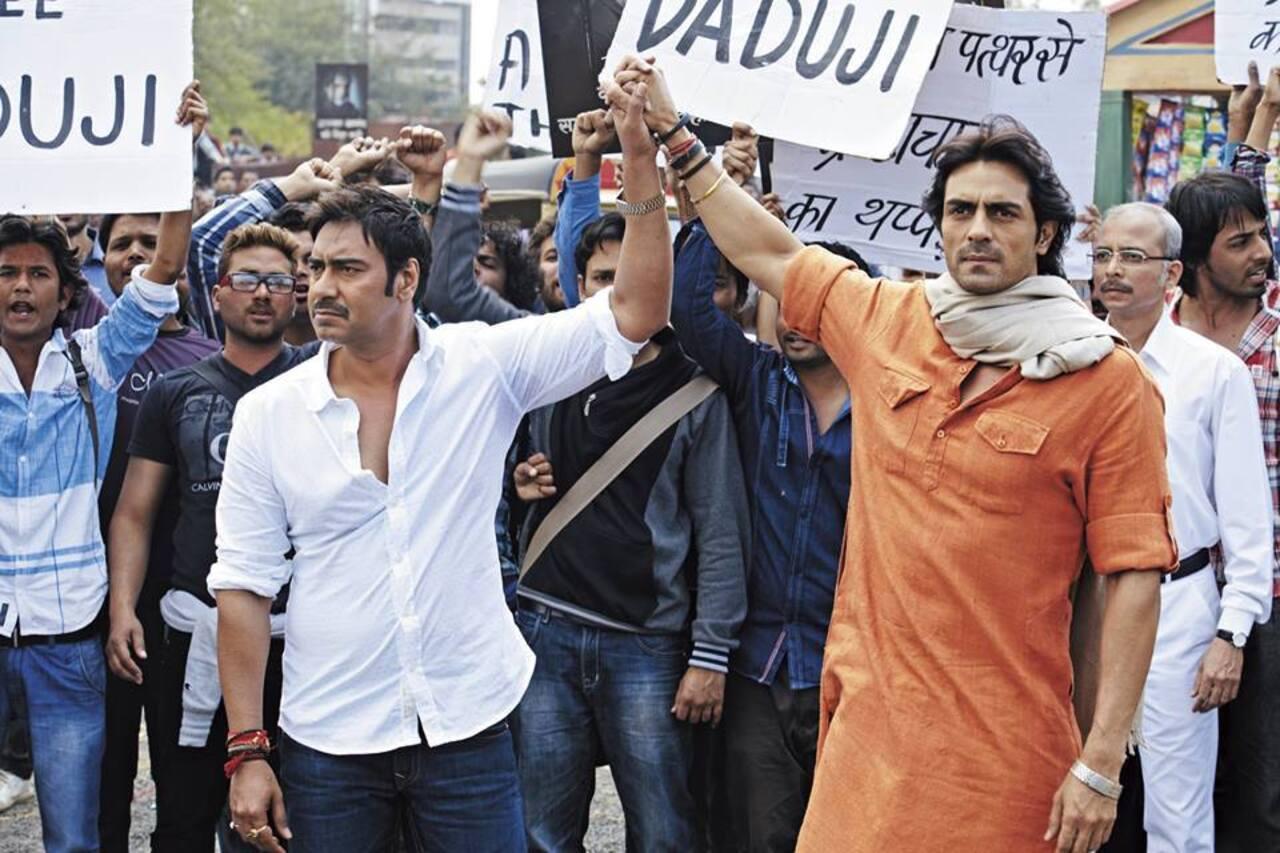 Satyagraha (2013): 
Dwarka Anand serves prison time for assaulting a corrupt official while trying to obtain due compensation for his son's death. Manav, his son's friend, organises a multi-faceted campaign to free him. Directed by Prakash Jha, the film stars Ajay Devgn, Arjun Rampal, Amitabh Bachchan, Kareena Kapoor Khan, Manoj Bajpayee, Amrita Rao and others