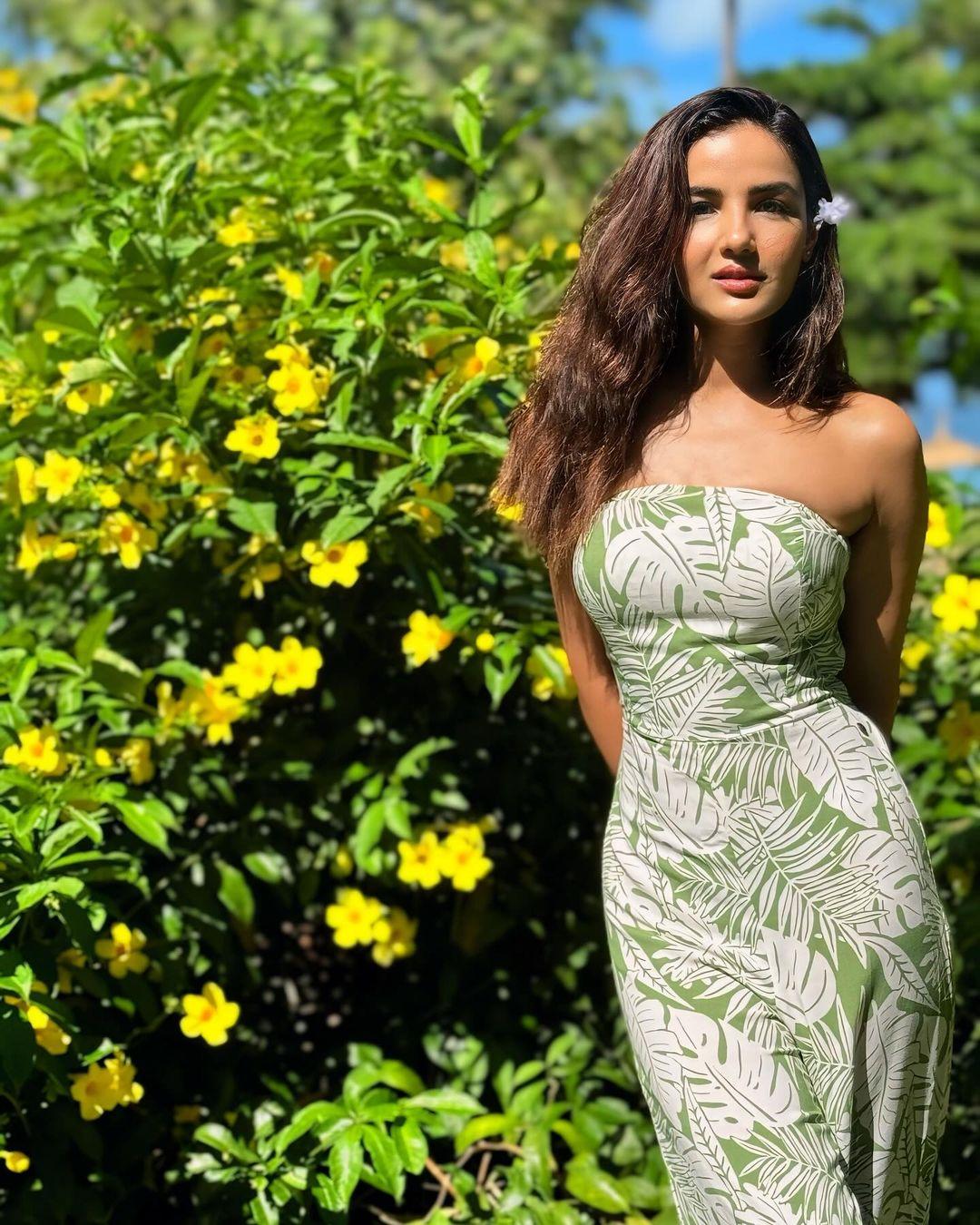 One of the looks during Jasmin's vacation featured a green and white off-shoulder dress which matched her green surroundings