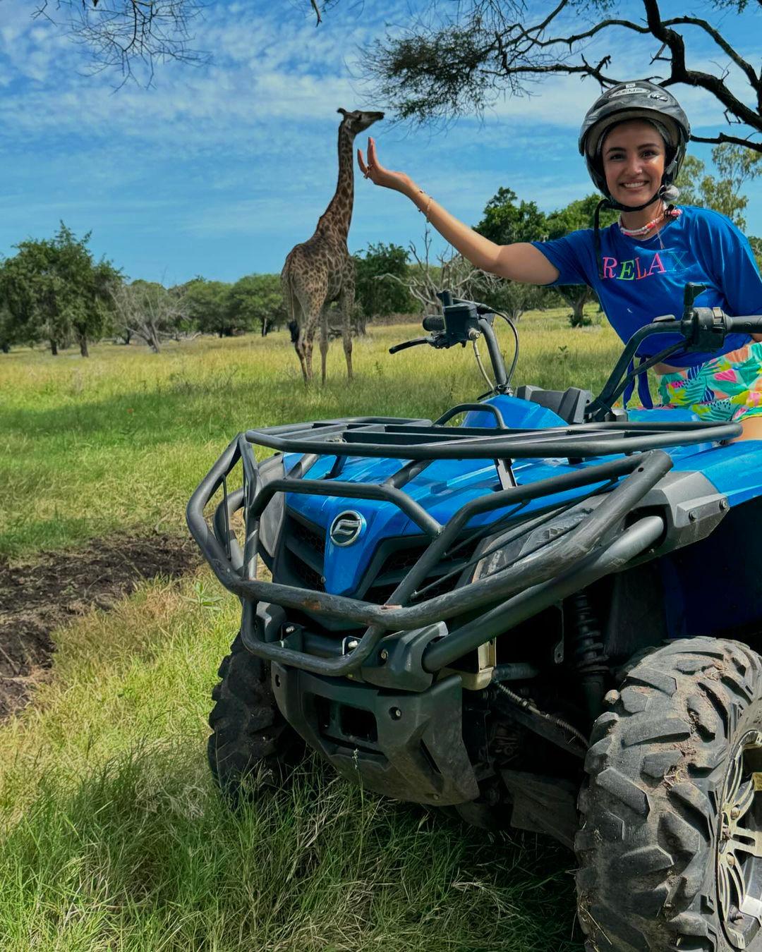 She seemed to have come across a variety of animals in the jungle. Here Jasmin pretends to be touching a giraffe, which is far away in the background