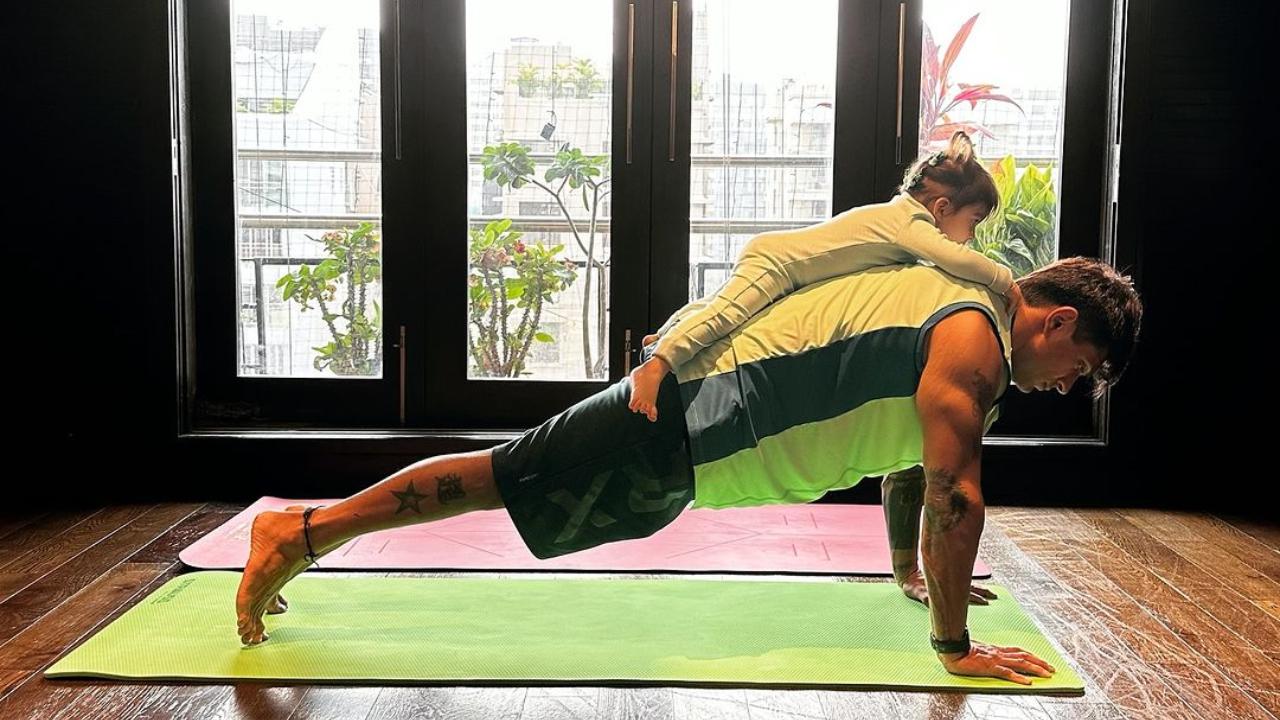 Karan Singh Grover posted a picture of him doing a plank with his daughter on his back