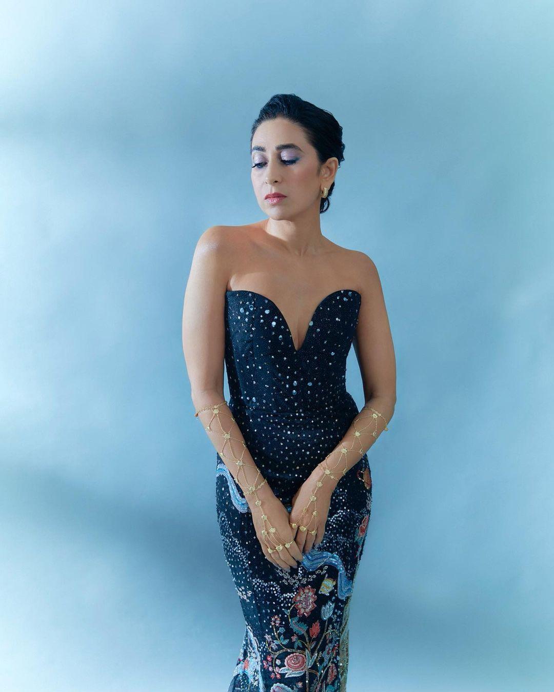 The strapless deep blue gown featured a plunging neckline and hugged her curves elegantly. Its intricate multi-coloured 3D embroidery and long train added a unique flair to her look. 